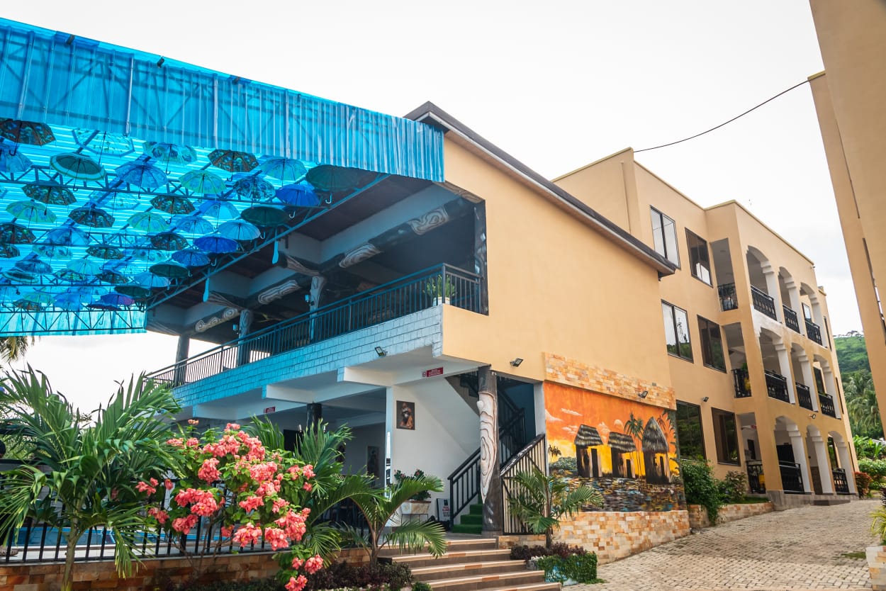 NS LUXURY VILLA, its blue canopy, landscaped courtyard and apartment building