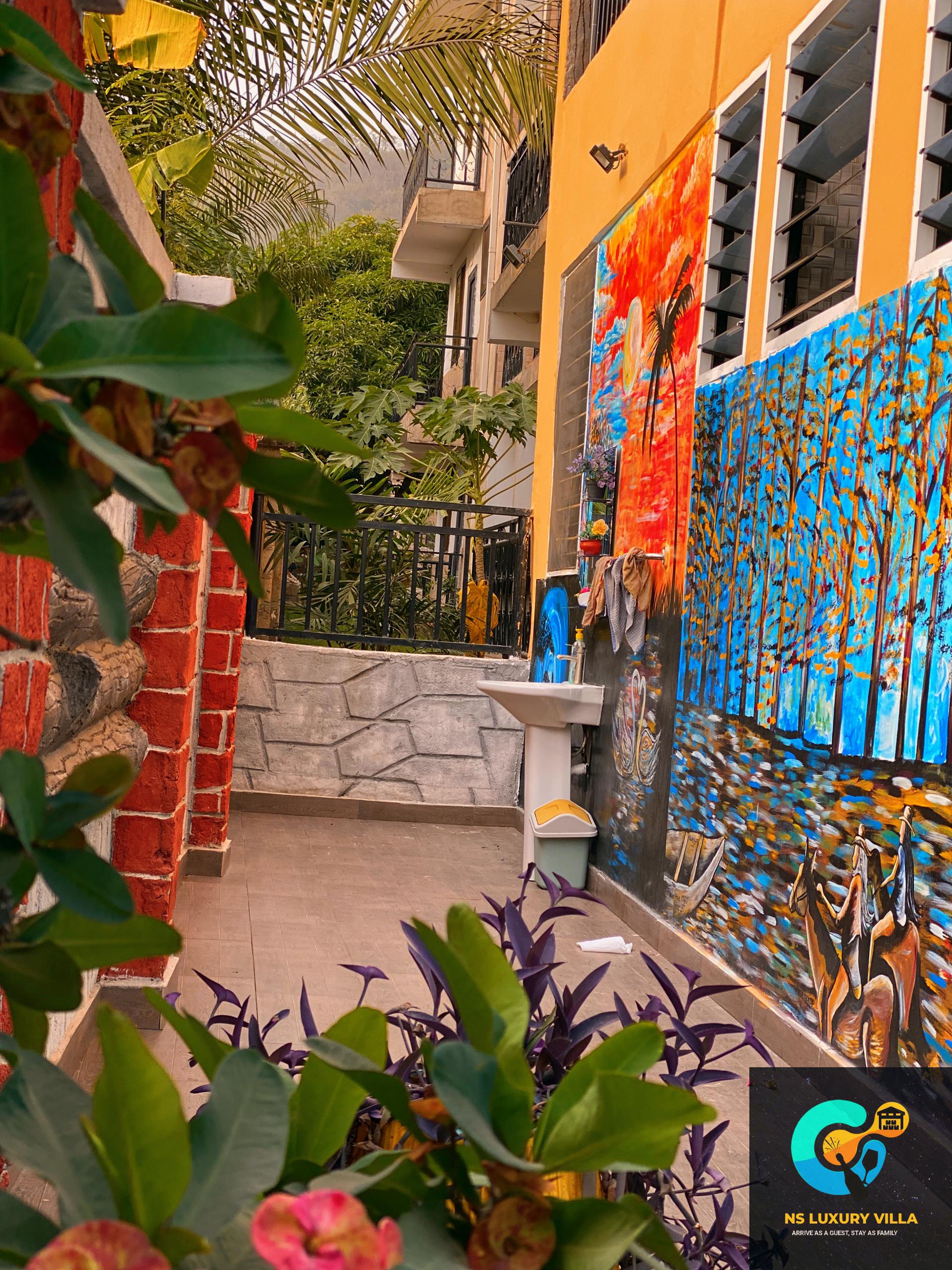 Hand-painted mural along the villa walkway